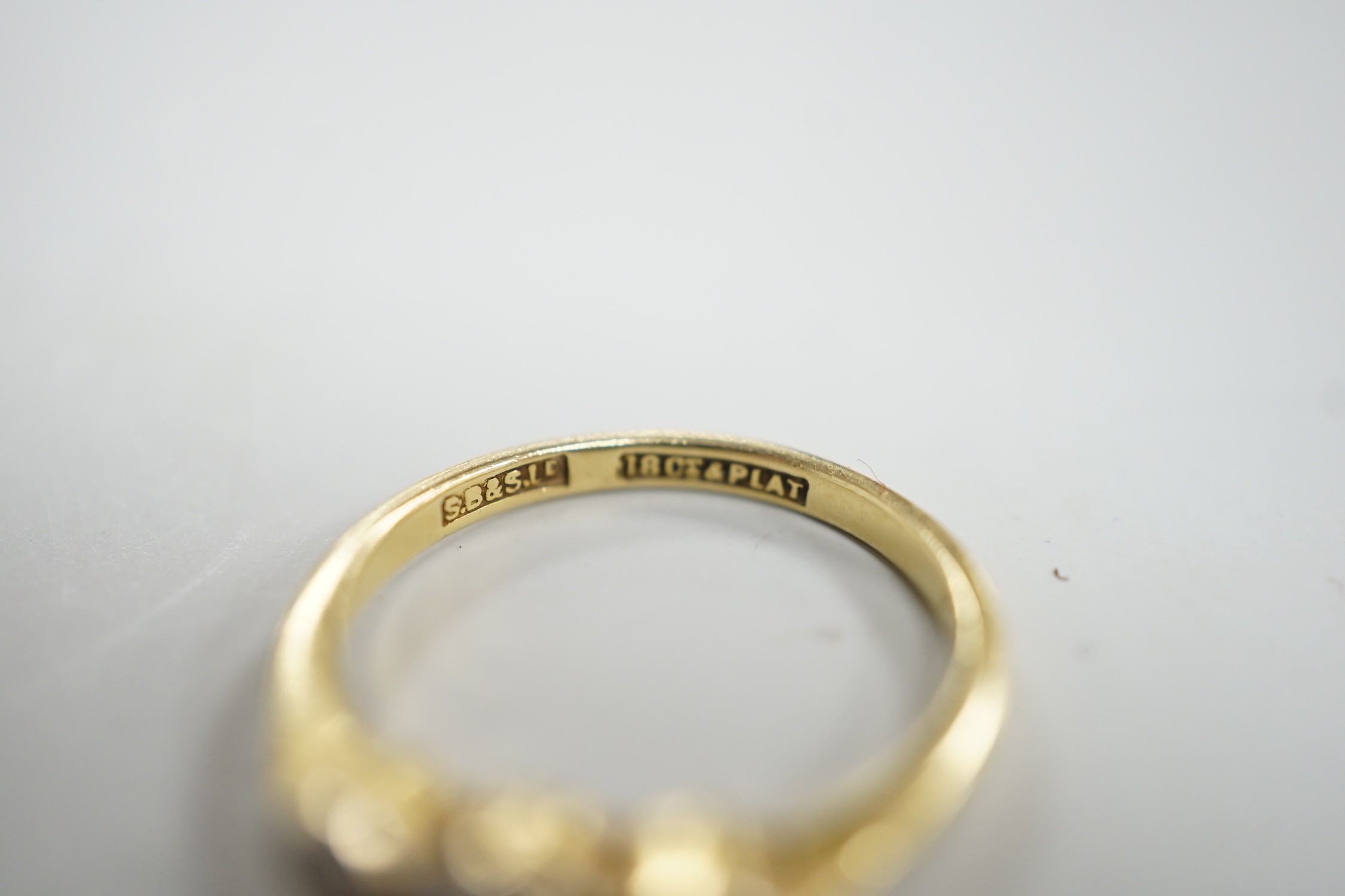 A mid 20th century 18ct, plat and three stone collet set diamond ring, size M, gross weight 2.5 grams.